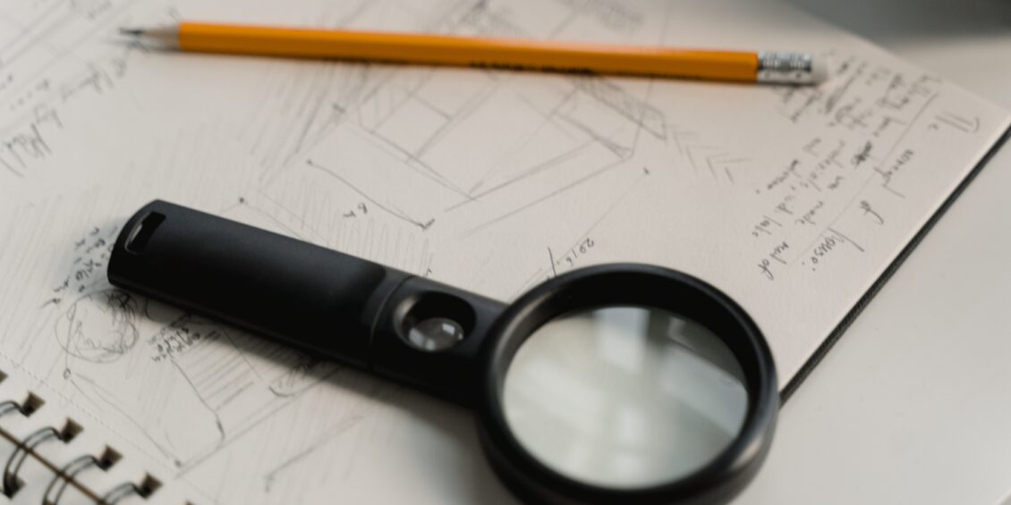magnifying glass with pencil